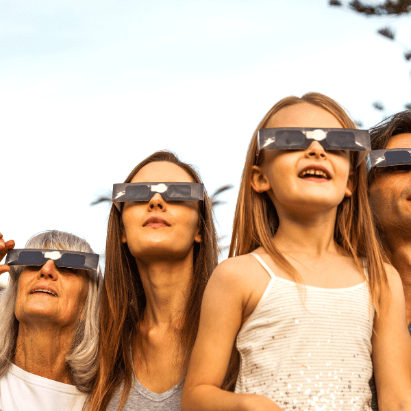 Family looking at a solar eclipse with protective eyeware on