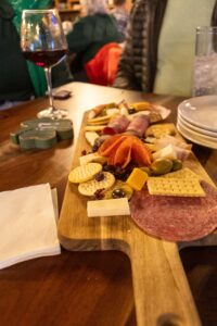 charcuterie board with glass of wine