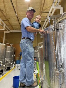Mike and Hadley Jo in the production room checking on a batch of wine
